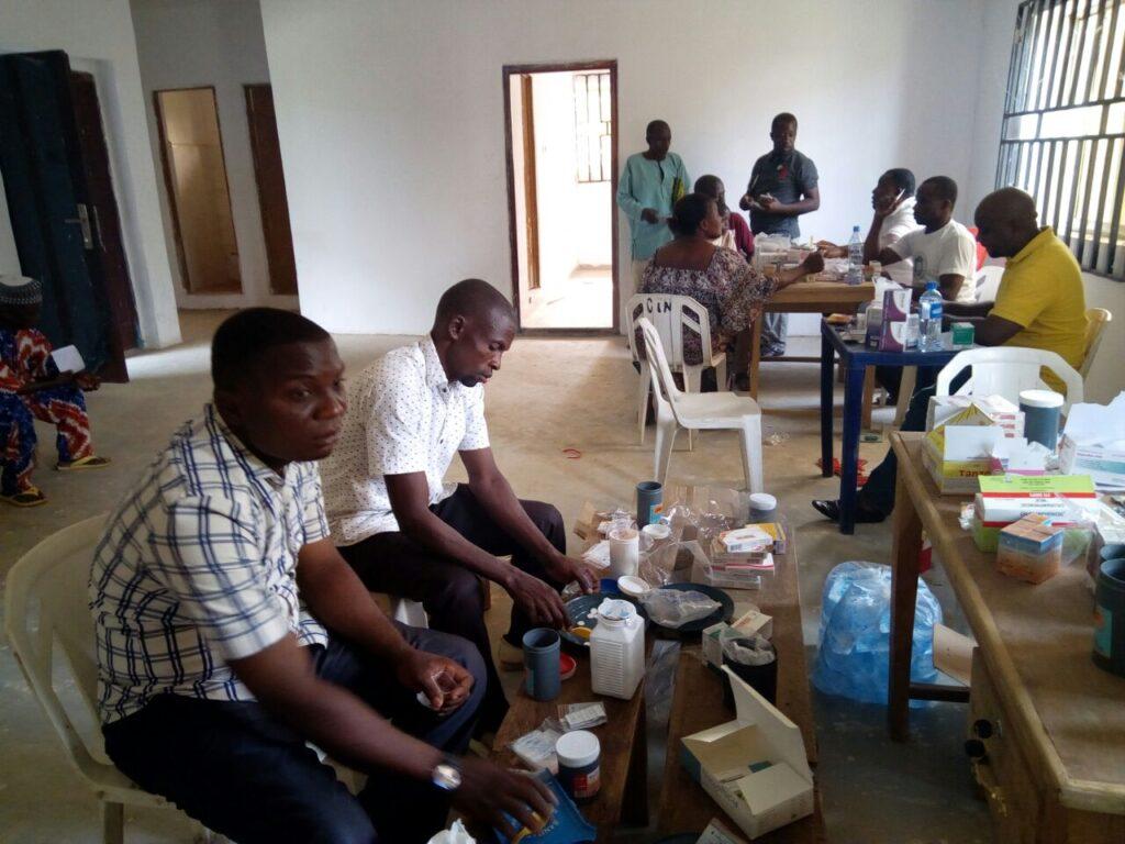 Pharm Cyprian Njoalu (yellow T-shirt) with pharmacy team members