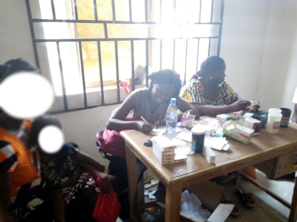 Pharm Doofan Shambe (middle) with a colleague and patient inside the pharmacy